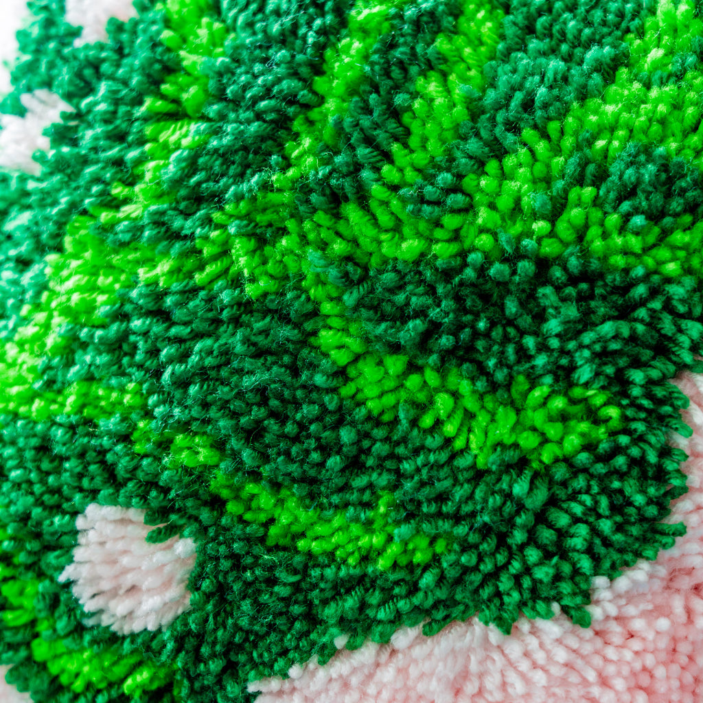 Close up of latch hook knots on lush and leafy cushion